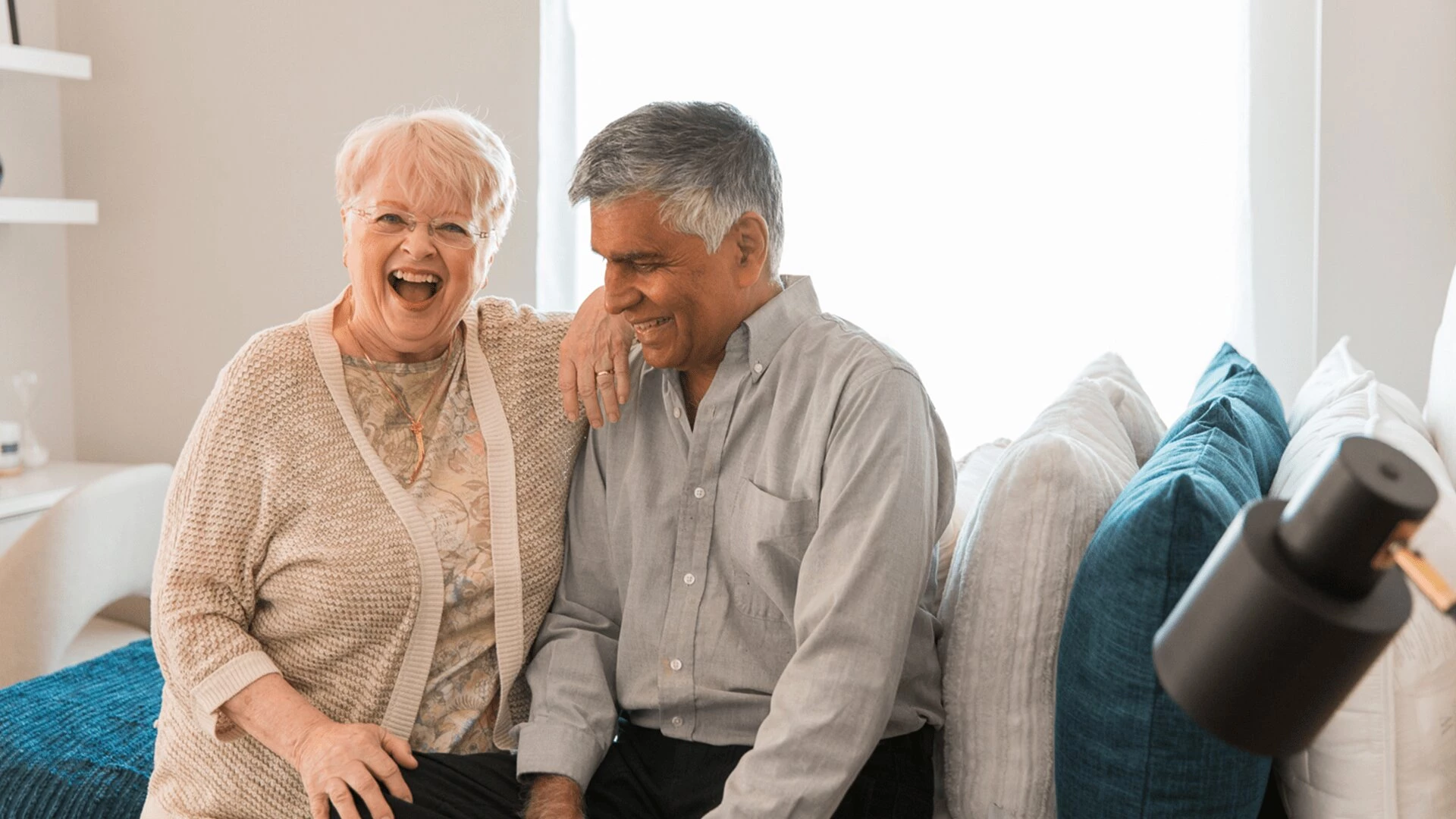 An elderly couple cuddling at Aspen House